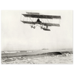 Vintage aircraft M. Van den Born flying above the sea Old photograph reproduction.