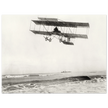 Vintage aircraft M. Van den Born flying above the sea Old photograph reproduction.