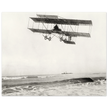 Vintage aircraft M. Van den Born flying above the sea Old photograph reproduction.