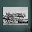 World War 2 black and white photograph. Railroad gun with soldiers on top.