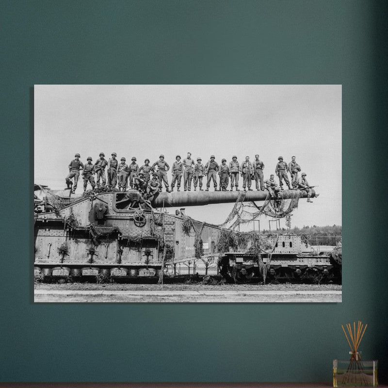 World War 2 black and white photograph. Railroad gun with soldiers on top.
