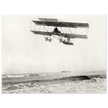 Vintage aircraft M. Van den Born flying above the sea Old photograph reproduction.