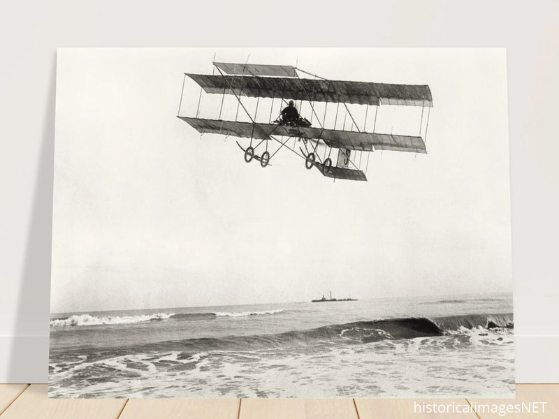 Vintage aircraft M. Van den Born flying above the sea Old photograph reproduction.
