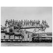 World War 2 black and white photograph. Railroad gun with soldiers on top.