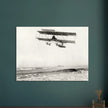 Vintage aircraft M. Van den Born flying above the sea Old photograph reproduction.