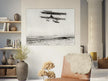 Vintage aircraft M. Van den Born flying above the sea Old photograph reproduction.