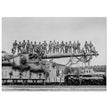 World War 2 black and white photograph. Railroad gun with soldiers on top.