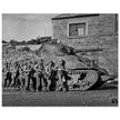 World war 2 black and white photograph. tank and american soldiers advancing in Belgium
