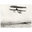 Vintage aircraft M. Van den Born flying above the sea Old photograph reproduction.