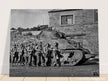 World war 2 black and white photograph. tank and american soldiers advancing in Belgium