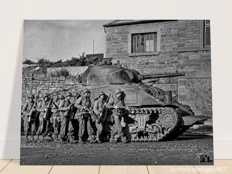 World war 2 black and white photograph. tank and american soldiers advancing in Belgium
