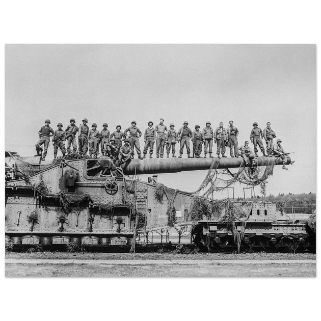 World War 2 black and white photograph. Railroad gun with soldiers on top.