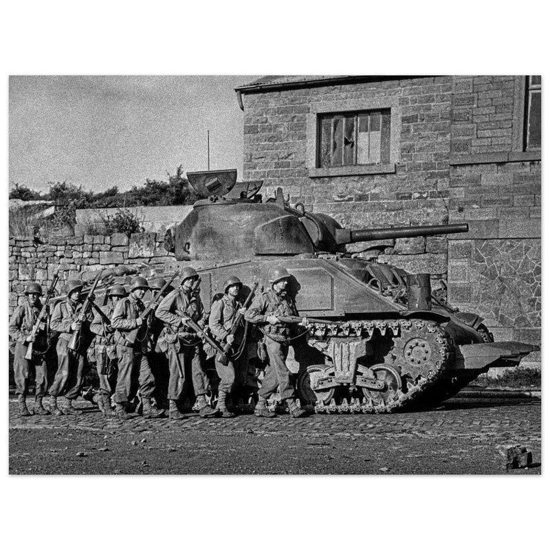 World war 2 black and white photograph. tank and american soldiers advancing in Belgium