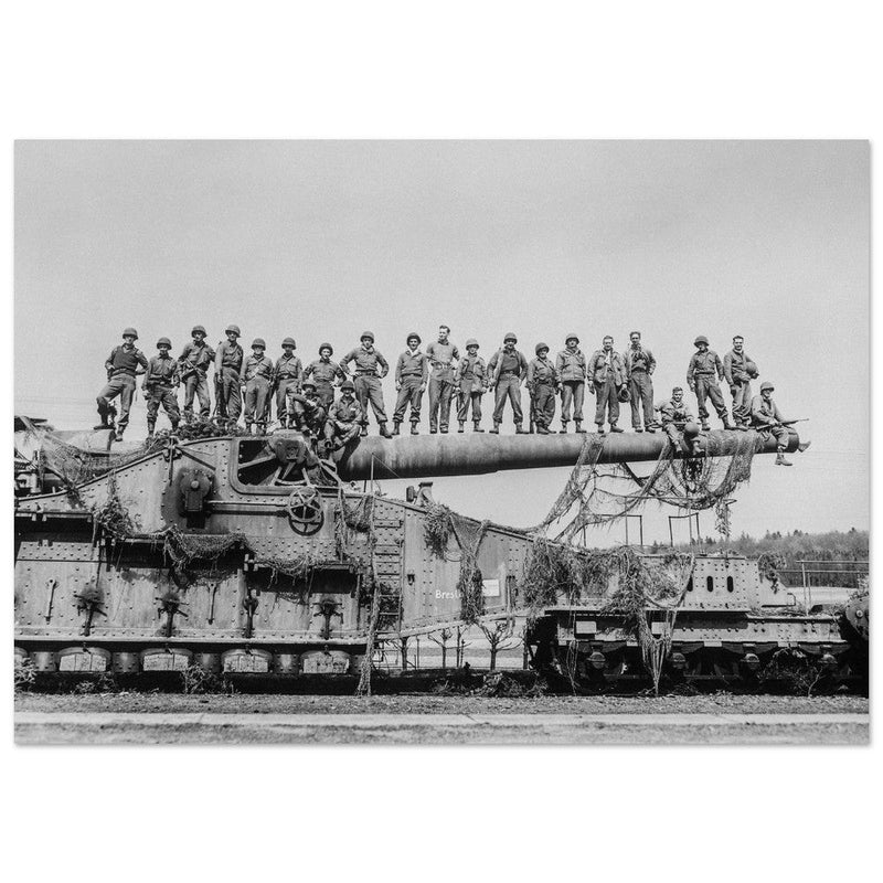 World War 2 black and white photograph. Railroad gun with soldiers on top.