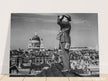 Second World War historic black and white photograph. Aircraft spotter on a roof in London.